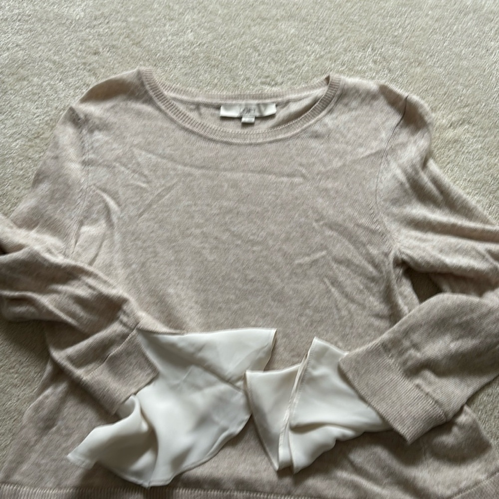 Crème seater with look of shirt underneath but it is one piece